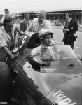 1958 Racing driver Stuart Lewis-Evans adjusts his helmet at Silverstone.jpg