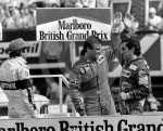 Prost, Renault RE40, Patrick Tambay, Ferrari 126C3, and Nelson Piquet, Brabham BT52B, on the podium, British Grand Prix, Silverstone, 1983.jpg